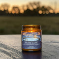 Home Game candle in amber glass jar, mint and spruce scent, hand poured in Medicine Hat, Alberta.