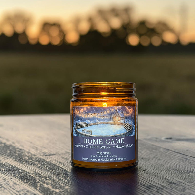 Home Game candle in amber glass jar, mint and spruce scent, hand poured in Medicine Hat, Alberta.