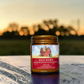 Red Barn candle in amber glass jar, leather and weathered wood scent, hand poured in Medicine Hat, Alberta
